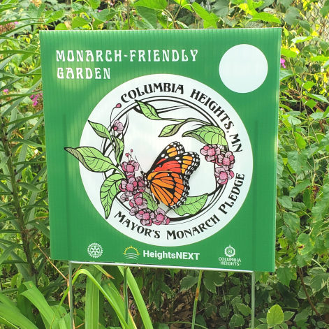 Mayor's Monarch Pledge lawn sign in a pollinator friendly garden